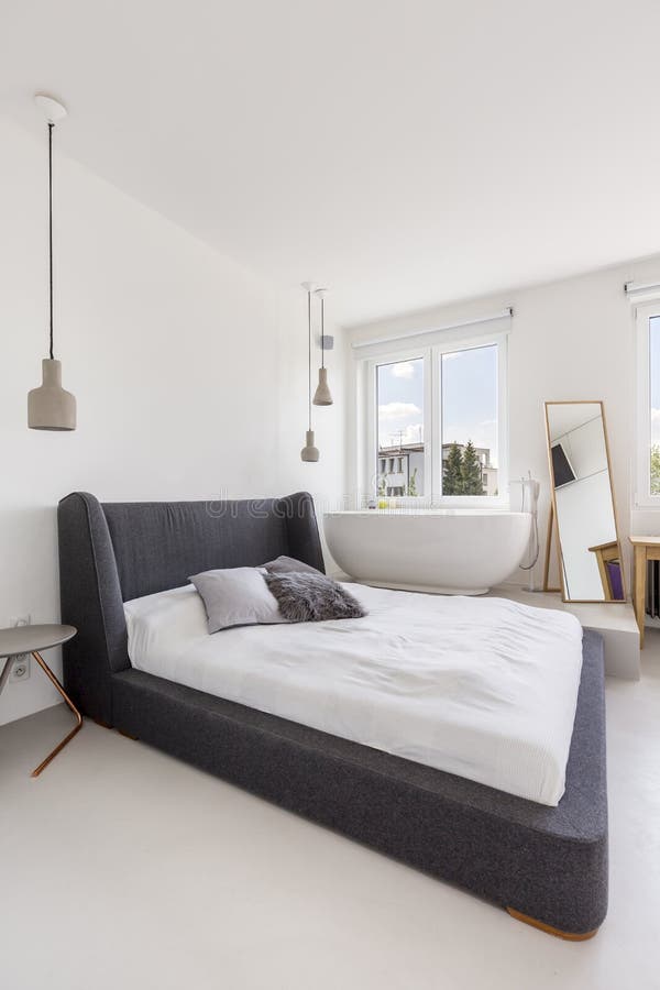 Shot of a spacious bedroom with a double bed and a stand-alone bathtub. Bathtub stand stock images, royalty-free photos and pictures