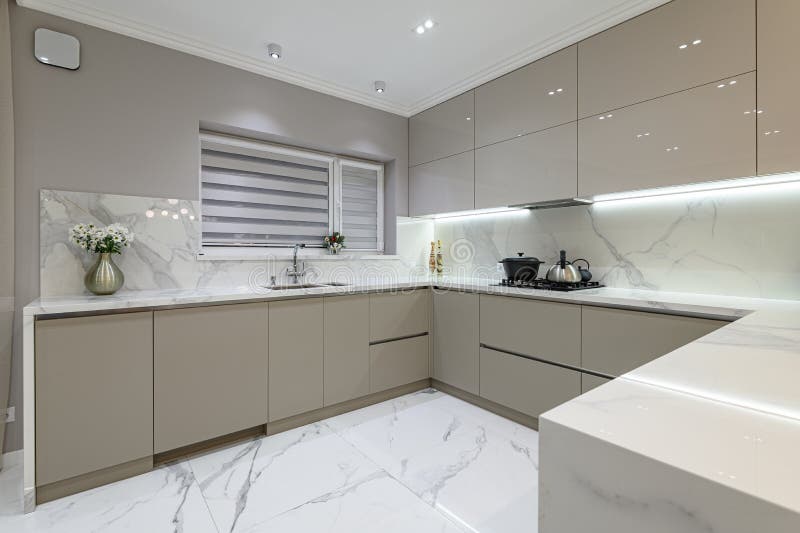 Beautiful modern kitchen design, kitchen faucet and kitchen decor, gray  marble kitchen island Stock Photo