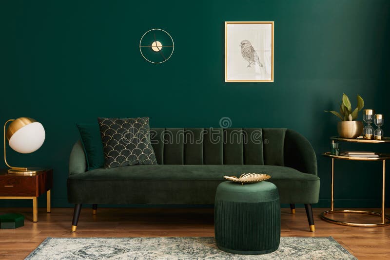 Luxury living room in house with modern interior design, green velvet sofa, coffee table, pouf, gold decoration, plant, lamp.
