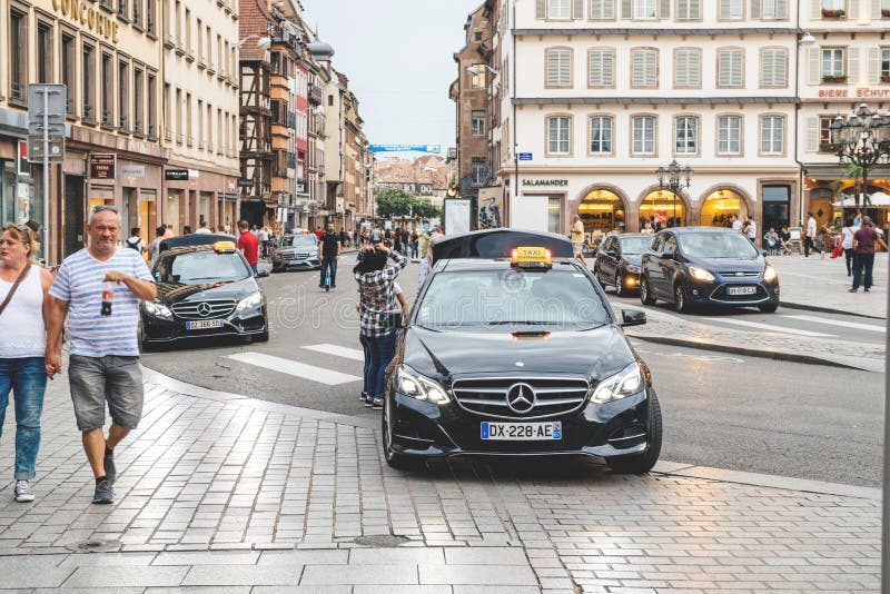 STRASBOURG, FRANCE - SEP 21, 2014: White Mercedes-Benz E Class taxi parked  on a rainy day in center of Strasbourg, place Kleber next to cafe Stock  Photo - Alamy