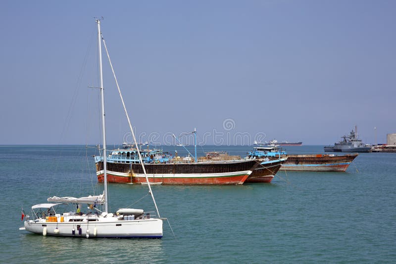 Luxury sailing boat, fishing and cargo ships at anchor in the port of Djibouti