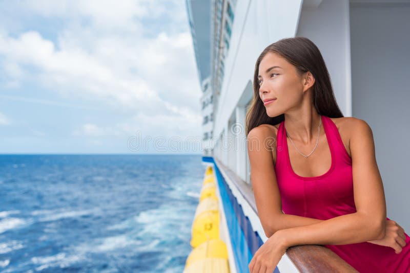 Luxury travel cruise vacation Asian elegant lady on holiday ship in Caribbean destination getaway. Tourist girl in red dress on