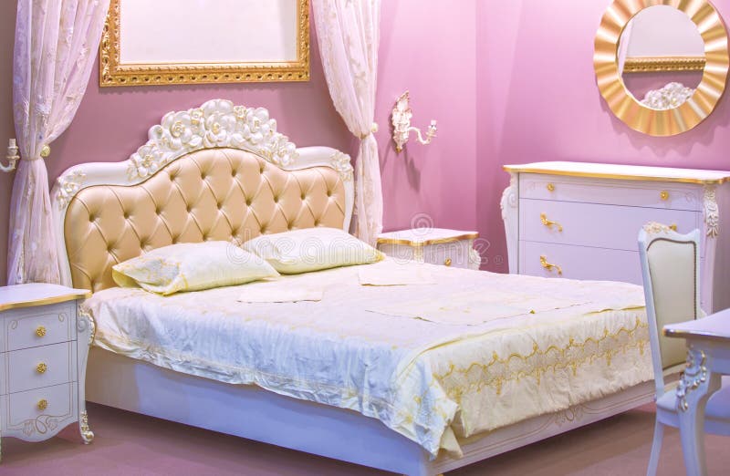Luxury white and pink bedroom in antique style with rich decor . Interior of a classic style bedroom in luxury apartment stock photo Luxury white and pink bedroom in antique style with rich decor . Interior of a classic style bedroom in luxury apartment stock photo