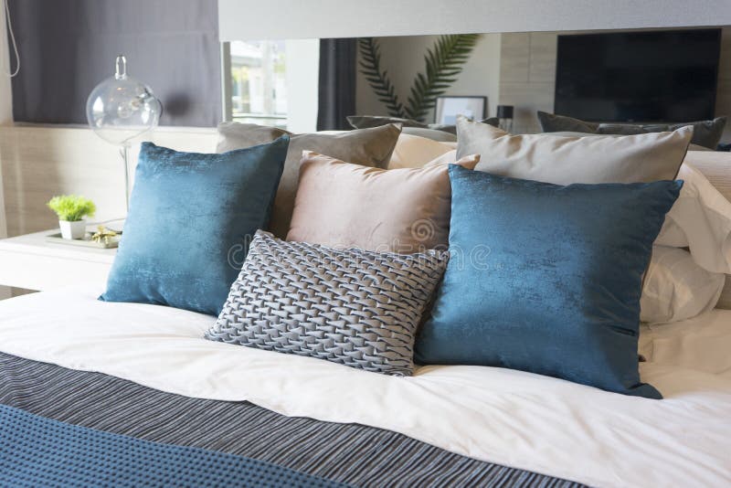 Luxury set of blue and gray pillows on bed in bedroom. Luxury set of blue and gray pillows on bed in bedroom