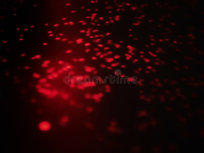Luz brilhante defocused vermelha borrada Alargamento da lente Pontos brilhantes Fundo escuro imagens de stock Luz brilhante defocused vermelha borrada Alargamento da lente Pontos brilhantes Fundo escuro imagens de stock