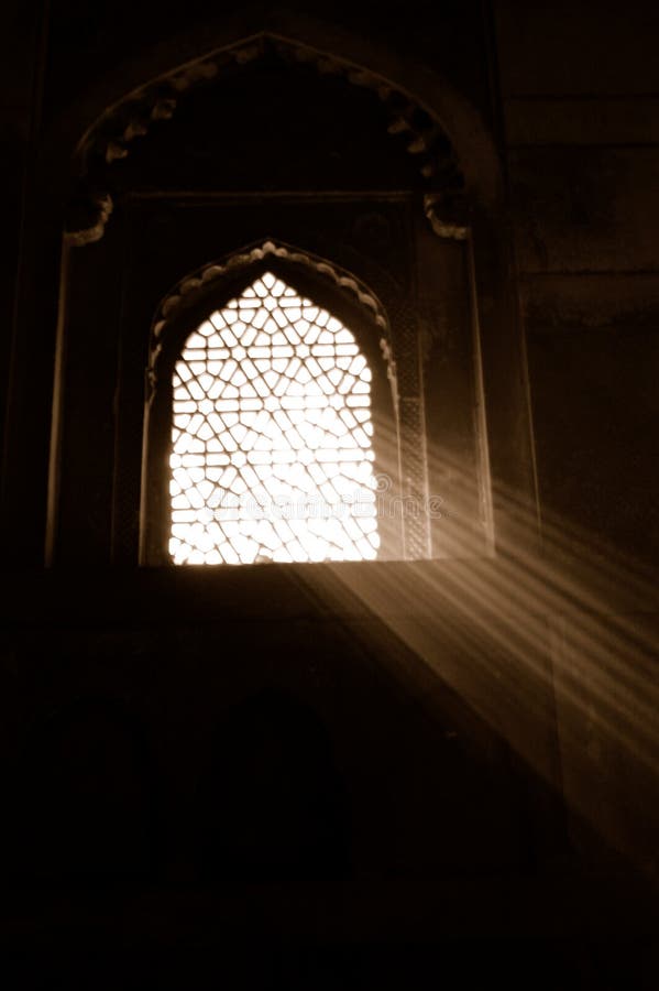 Sunlight streaming through ornate window in Agra, India. Sunlight streaming through ornate window in Agra, India.