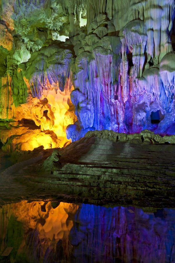 The colorful lights inside Sung Sot cave in Vietnam reflect in the waters. The colorful lights inside Sung Sot cave in Vietnam reflect in the waters.