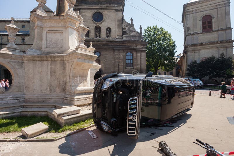 LVIV, UKRAINE - JUNE 18: The body of a pedestrian lays next to an overturned SUV on 18 June 2017 in Lviv, Ukraine. The accident occurred in front of a crowded church. LVIV, UKRAINE - JUNE 18: The body of a pedestrian lays next to an overturned SUV on 18 June 2017 in Lviv, Ukraine. The accident occurred in front of a crowded church.