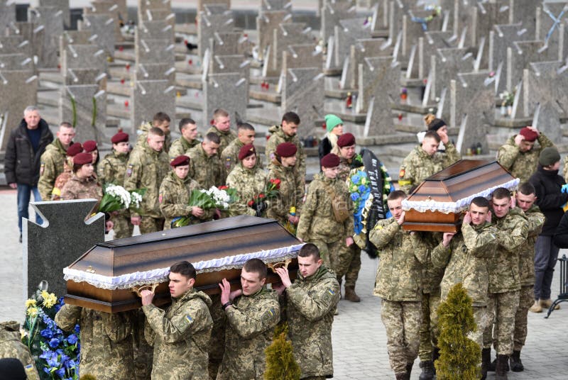 Lviv, Ukraine - March 9, 2022: Servicemen carry coffins during funerals of Ukrainian servicemen killed during Russia`s invasion o