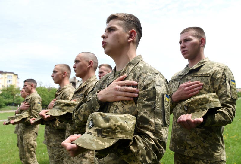 Lviv, Ukraine - May 16, 2022: Soldiers sings Anthem during Funerals of Ukrainian servicemen, killed during the Russian invasion of