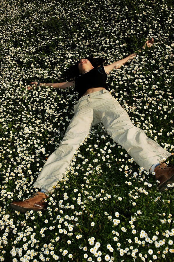 Happy girl rolling in the flowers. Happy girl rolling in the flowers