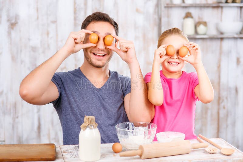Lycklig fader och dotter som tillsammans bakar royaltyfria bilder Lycklig fader och dotter som tillsammans bakar royaltyfria bilder