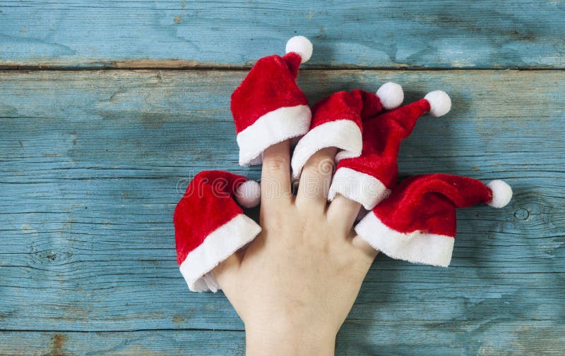 lycklig familj med fingrar i jultomtenhattar på träbakgrund royaltyfri fotografi lycklig familj med fingrar i jultomtenhattar på träbakgrund royaltyfri fotografi