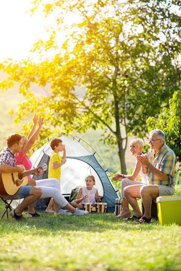 Happy family enjoying on summer day on camping. Happy family enjoying on summer day on camping