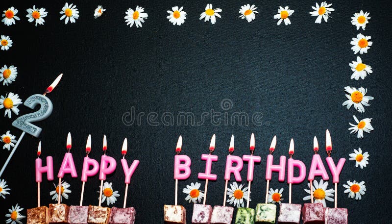Happy birthday background with number 2. Copy space. Pink happy birthday candles on a black background. Happy birthday flower frame. Happy birthday background with number 2. Copy space. Pink happy birthday candles on a black background. Happy birthday flower frame.