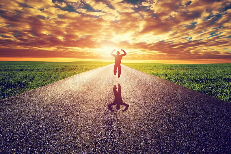 Happy man jumping on long straight road, way towards sunset sun. Travel, happiness, win, healthy lifestyle concepts. Happy man jumping on long straight road, way towards sunset sun. Travel, happiness, win, healthy lifestyle concepts.