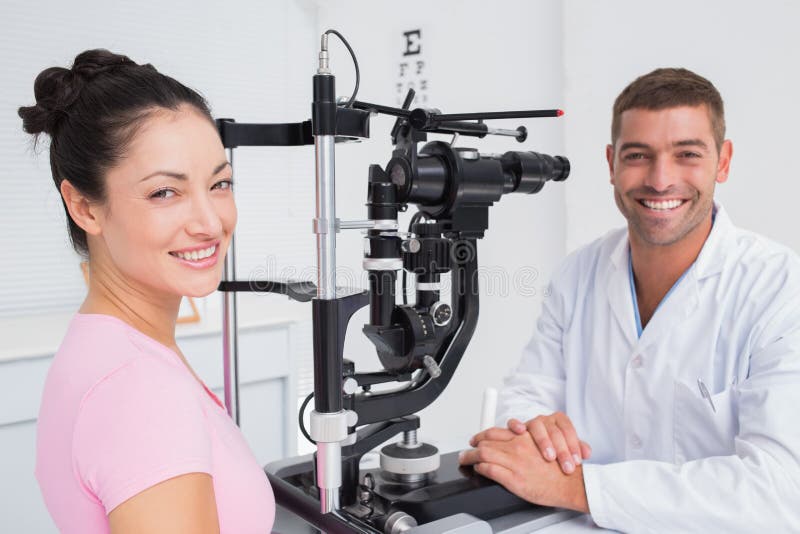 Lycklig optiker- och kvinnligpatient med den skurna upp lampan arkivfoto Lycklig optiker- och kvinnligpatient med den skurna upp lampan arkivfoto