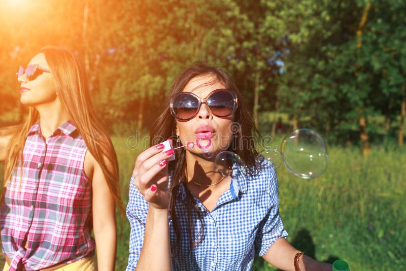 Happy friends in the park on a sunny day . Summer lifestyle portrait of three hipster women enjoy nice day, wearing bright sunglasses. Best friends girls having fun, joy. Lifestyle. Happy friends in the park on a sunny day . Summer lifestyle portrait of three hipster women enjoy nice day, wearing bright sunglasses. Best friends girls having fun, joy. Lifestyle