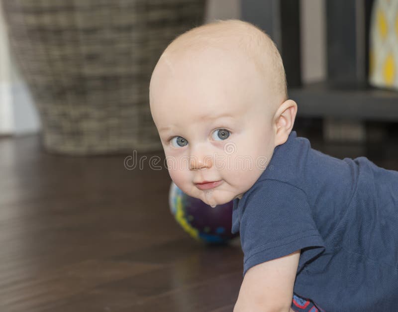 A beautiful Happy Teething Baby Boy Drools & Looks at the Camera. A beautiful Happy Teething Baby Boy Drools & Looks at the Camera