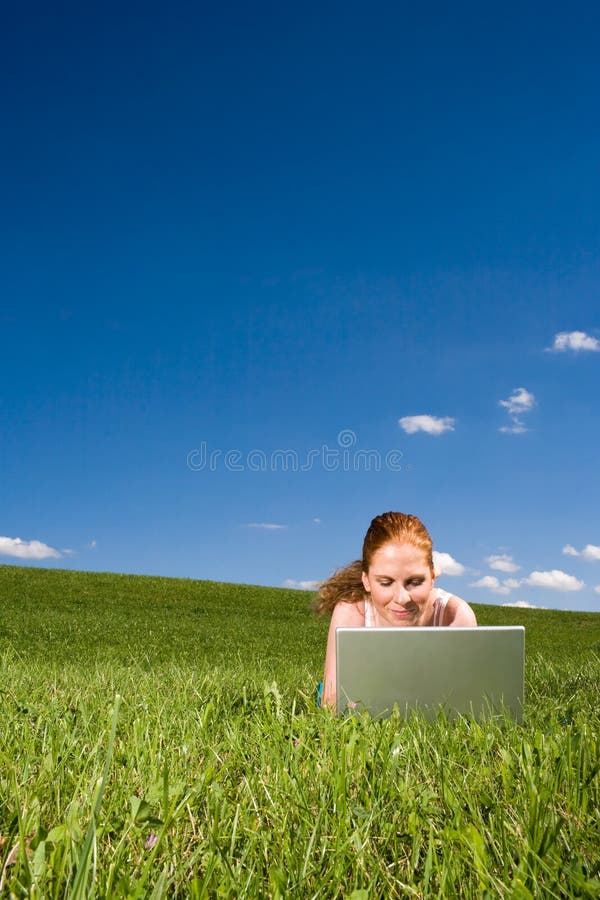 Lying in grass with internet