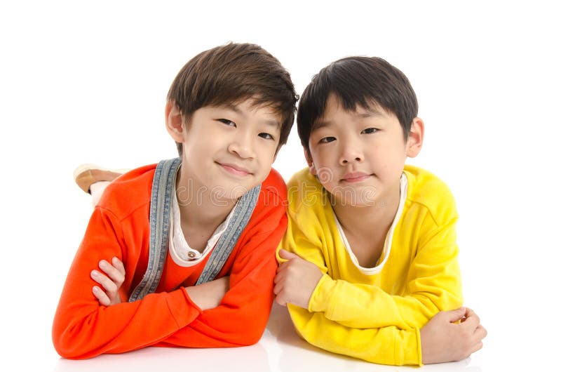 Lyinig asiatico sveglio dei bambini su fondo bianco fotografia stock libera da diritti Lyinig asiatico sveglio dei bambini su fondo bianco fotografia stock libera da diritti