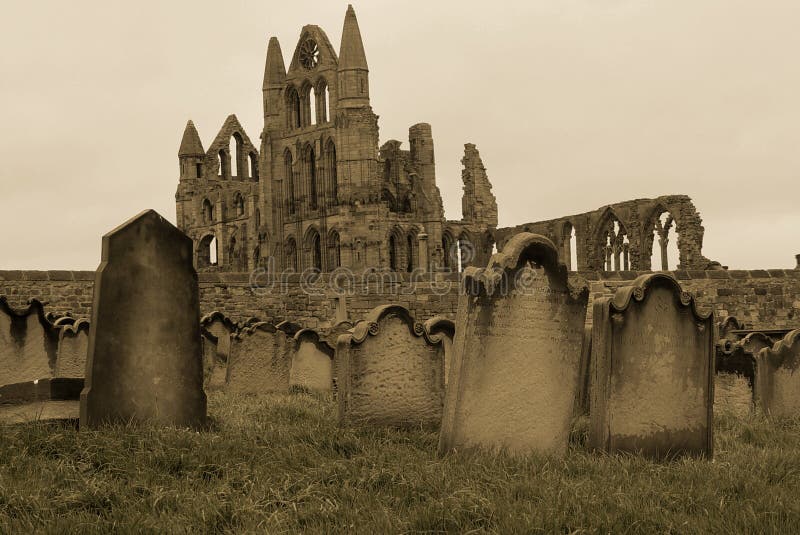 A sepia coloured picture of a graveyard in Whitby, UK, with the ruined abbey in the background. A sepia coloured picture of a graveyard in Whitby, UK, with the ruined abbey in the background