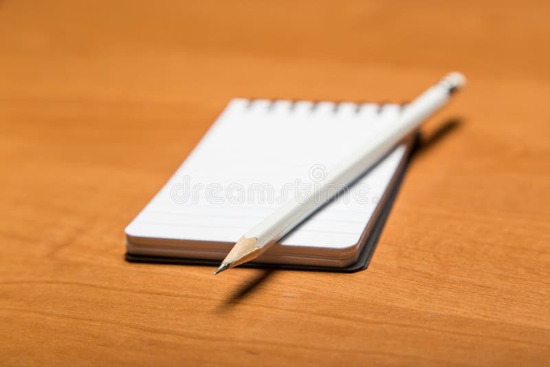 A sharp pencil and notepad with copy space. A sharp pencil and notepad with copy space.