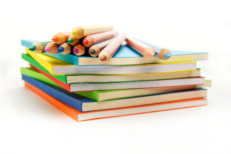 Twelve pencils on the surface of the stack of books. Twelve pencils on the surface of the stack of books