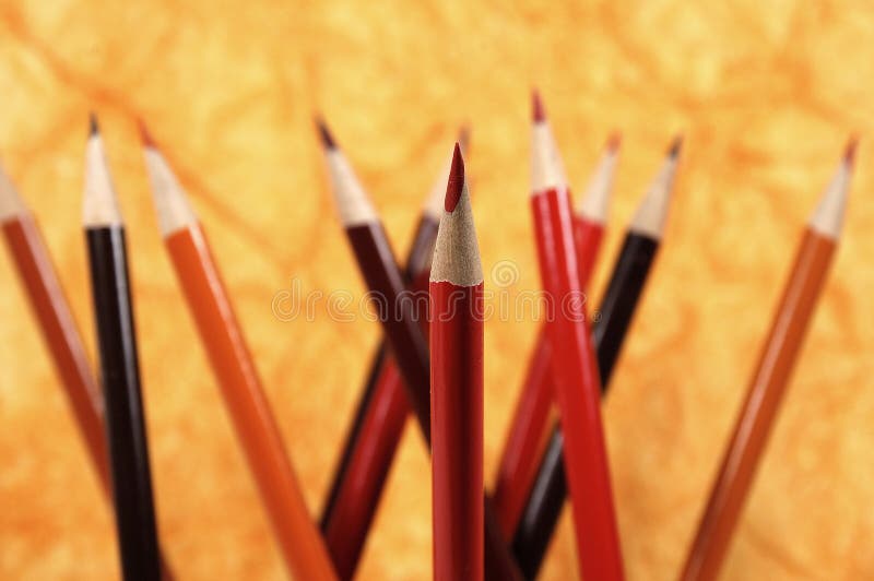 Photo of Orange, Red and Brown Pencils With Red Pencil In Sharp Focus. Photo of Orange, Red and Brown Pencils With Red Pencil In Sharp Focus.