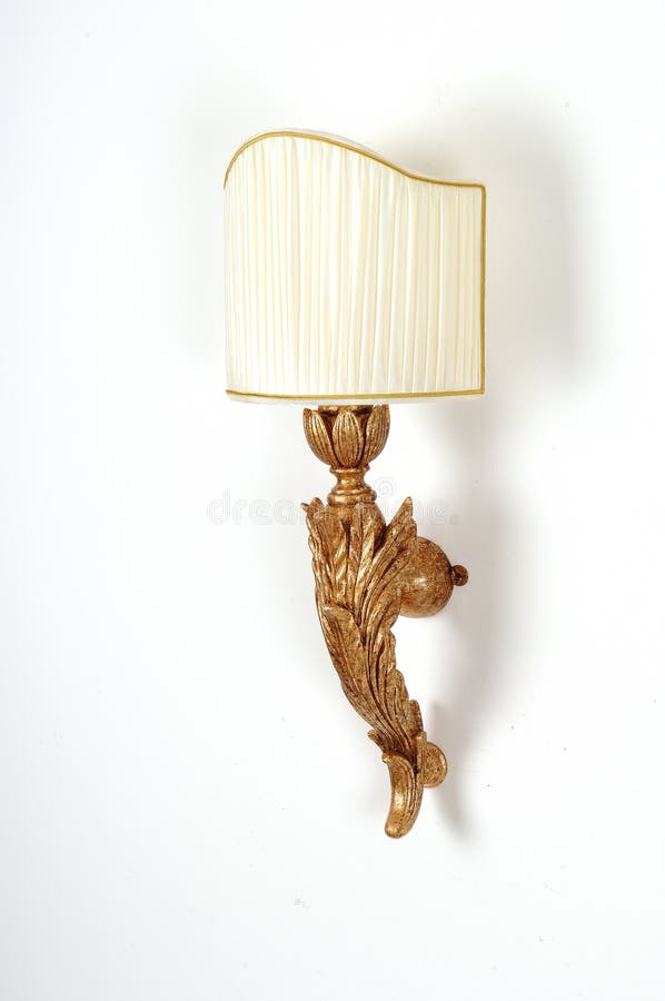 A view of a decorative, wooden wall lamp on white background. A view of a decorative, wooden wall lamp on white background.