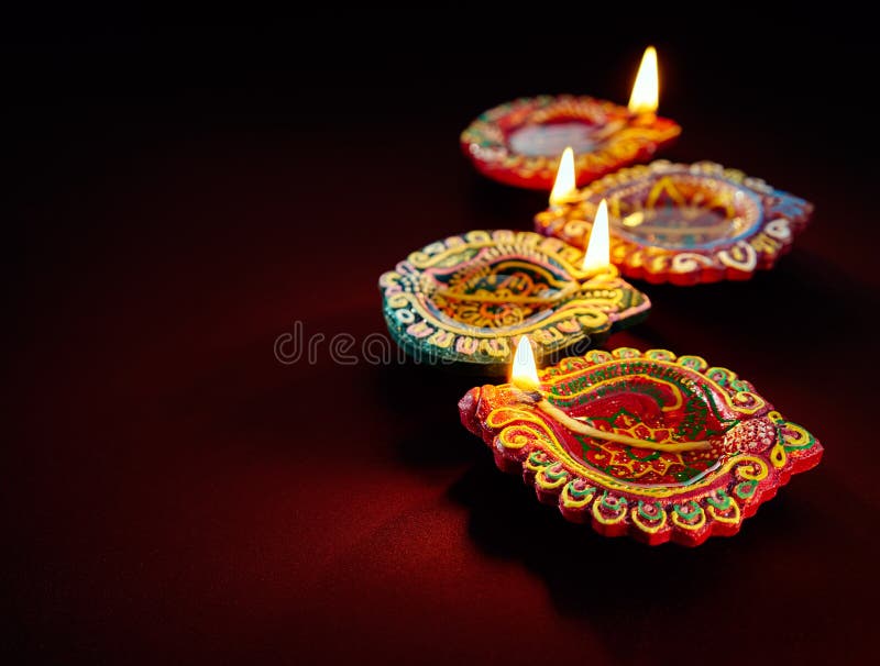 Colorful clay diya lamps lit during diwali celebration. Colorful clay diya lamps lit during diwali celebration