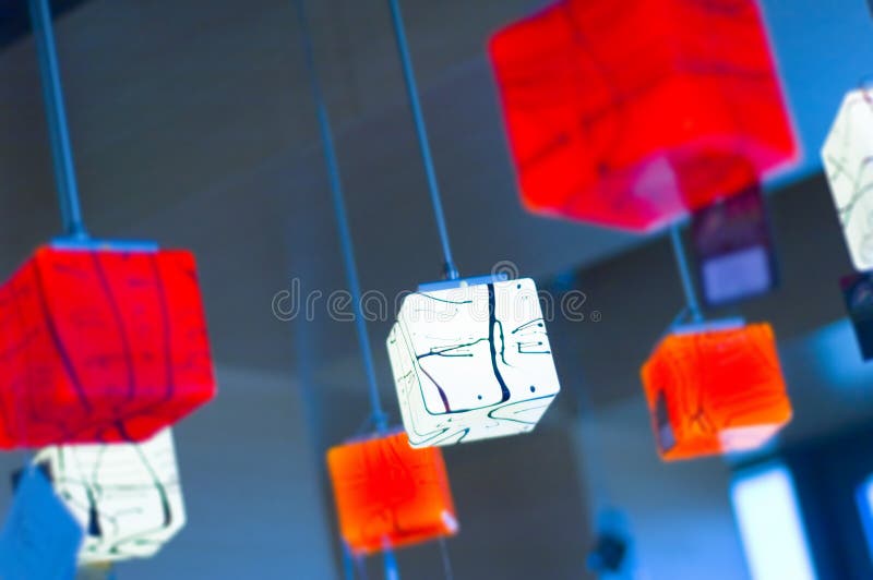 Red and white lit lamps hanging from the ceiling in lamp shop. Red and white lit lamps hanging from the ceiling in lamp shop.