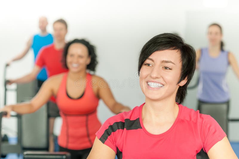 Lächelnde Frau am Eignungkategorien-Gymnastik-Training lizenzfreie stockbilder Lächelnde Frau am Eignungkategorien-Gymnastik-Training lizenzfreie stockbilder