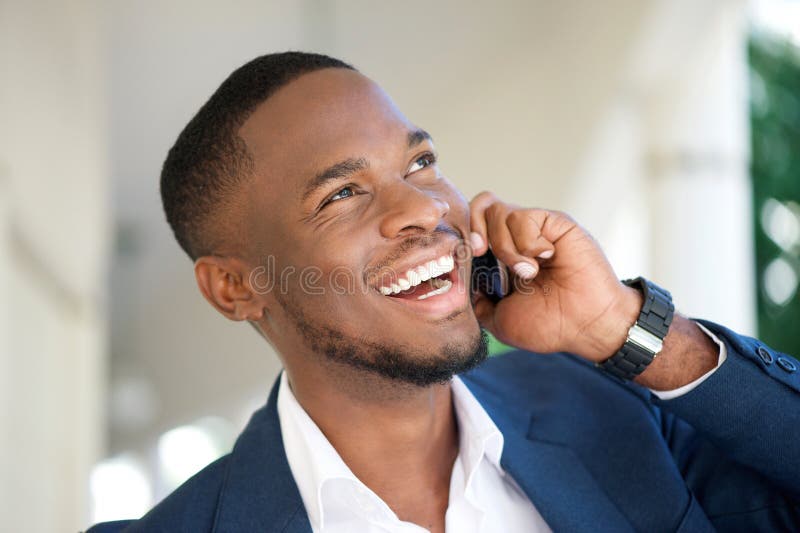 Lächelnder junger Geschäftsmann, der durch Handy nennt lizenzfreies stockfoto Lächelnder junger Geschäftsmann, der durch Handy nennt lizenzfreies stockfoto