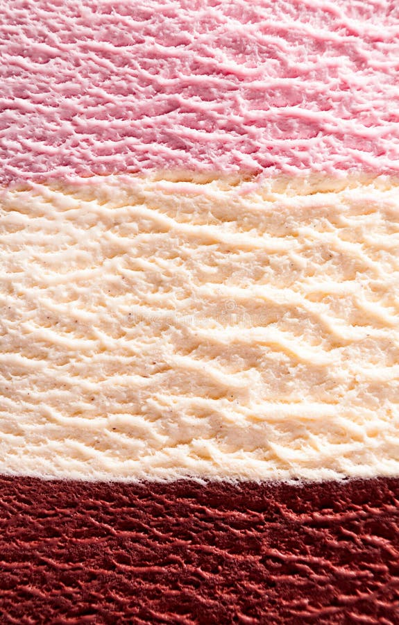 Horizontal close up of stacked strawberry, chocolate fudge and vanilla or Neapolitan flavor ice cream with delicious texture. Horizontal close up of stacked strawberry, chocolate fudge and vanilla or Neapolitan flavor ice cream with delicious texture