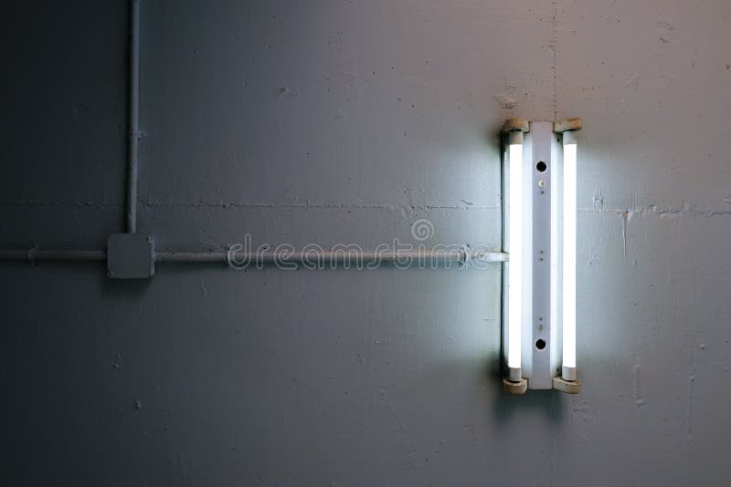 Långt lysrör som installeras på det konkreta taket i den industriella fabriken royaltyfri bild Långt lysrör som installeras på det konkreta taket i den industriella fabriken royaltyfri bild