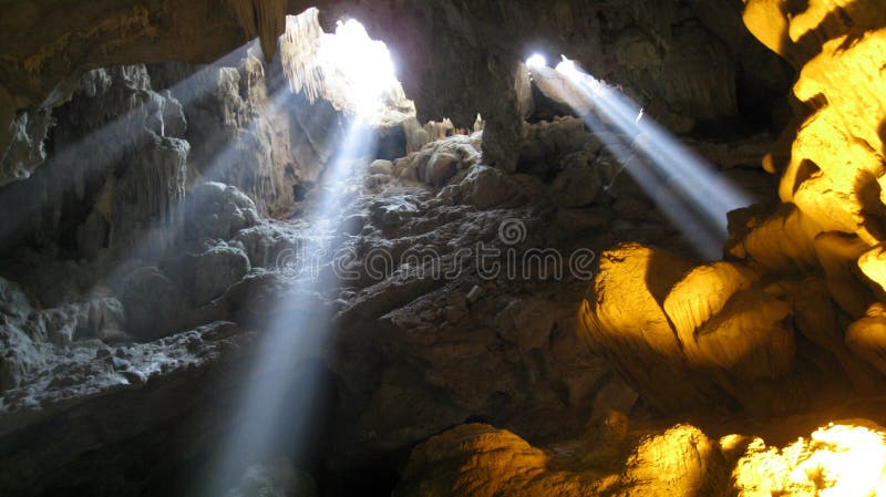Beams of light entering a dark cave. Beams of light entering a dark cave