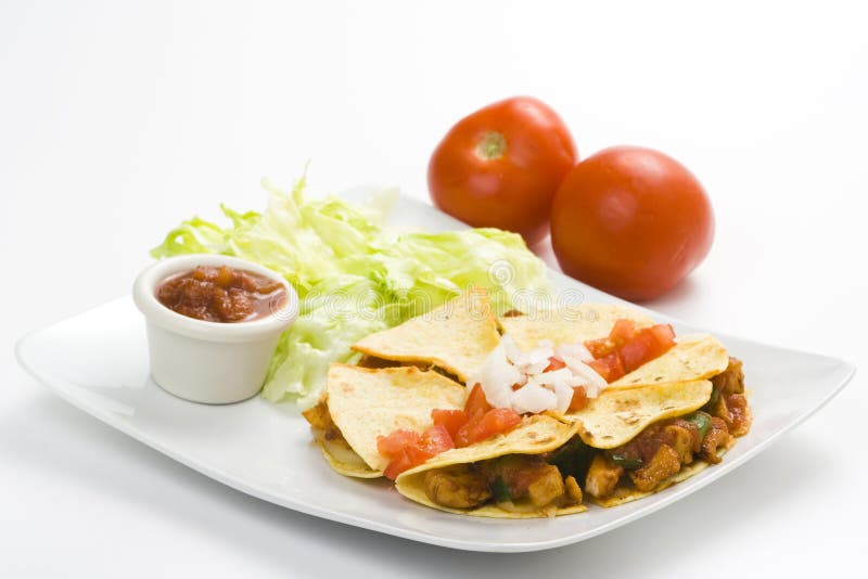 Delicious chicken quesadilla and fresh vegetables isolated. Delicious chicken quesadilla and fresh vegetables isolated