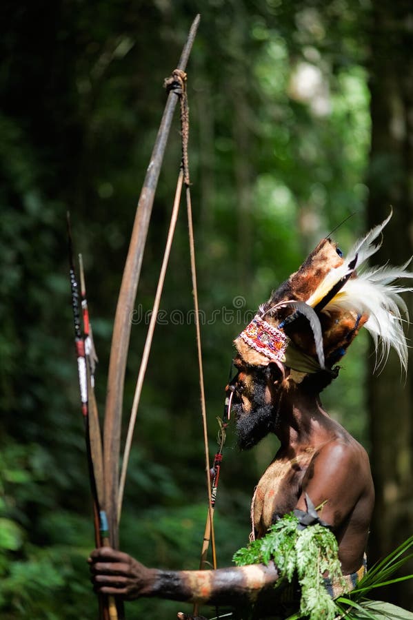 INDONESIA, NEW GUINEA, SECTOR SENGGI - 2 FEBRUARY 2009: The Leader of a Papuan tribe of Yafi in traditional clothes, ornaments and a coloring. New Guinea Island, Indonesia. 2 February 2009. INDONESIA, NEW GUINEA, SECTOR SENGGI - 2 FEBRUARY 2009: The Leader of a Papuan tribe of Yafi in traditional clothes, ornaments and a coloring. New Guinea Island, Indonesia. 2 February 2009