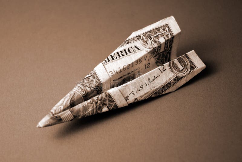 Sepia image of a paper plane made from an American $1 bill. Sepia image of a paper plane made from an American $1 bill.