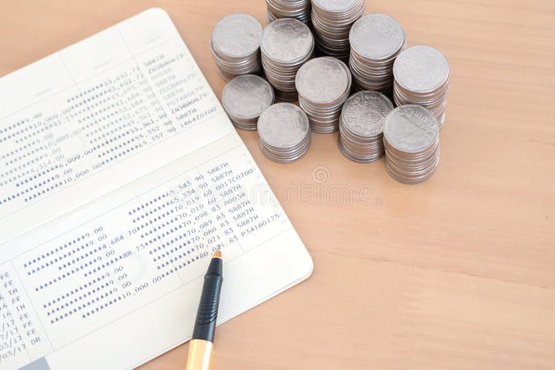 M?nzen und Stift auf Sparkontosparbuch lizenzfreie stockfotos M?nzen und Stift auf Sparkontosparbuch lizenzfreie stockfotos