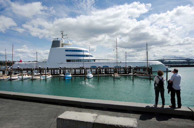 AUCKLAND - OCT 06:M/Y A luxury motor yacht mooring at Auckland's Wynyard Wharf on Oct 06 2013.With a length of 119 metres (390 ft) and displacing almost 6,000 tonnes, it is one of the largest motor yachts in the world. AUCKLAND - OCT 06:M/Y A luxury motor yacht mooring at Auckland's Wynyard Wharf on Oct 06 2013.With a length of 119 metres (390 ft) and displacing almost 6,000 tonnes, it is one of the largest motor yachts in the world.