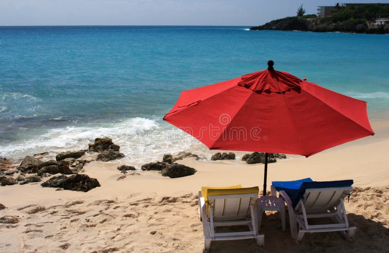 A couple of chairs and a big umbrella just for you, Maho Bay, St. Maarten. A couple of chairs and a big umbrella just for you, Maho Bay, St. Maarten.