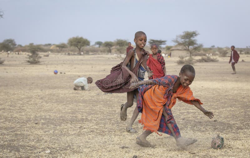 Maasai men playing soccer editorial image. Image of bush - 159038440