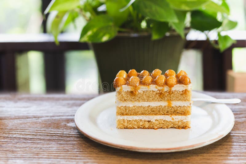 Macadamia Caramel Cake Topping with Macadamia Nuts with Coffee on Table. Stock Photo Image of