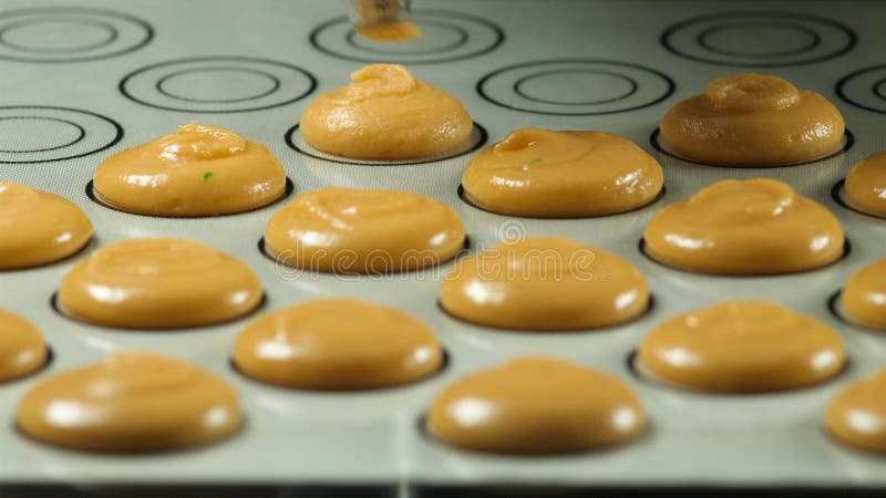 Macaron, dessert français, serrant la forme de la pâte faisant cuire le sac L'industrie alimentaire, la masse ou production de ma photographie stock Macaron, dessert français, serrant la forme de la pâte faisant cuire le sac L'industrie alimentaire, la masse ou production de ma photographie stock
