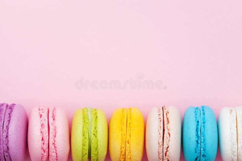 Colorful macaron or macaroon on pink background top view. Flat lay composition. Colorful macaron or macaroon on pink background top view. Flat lay composition.