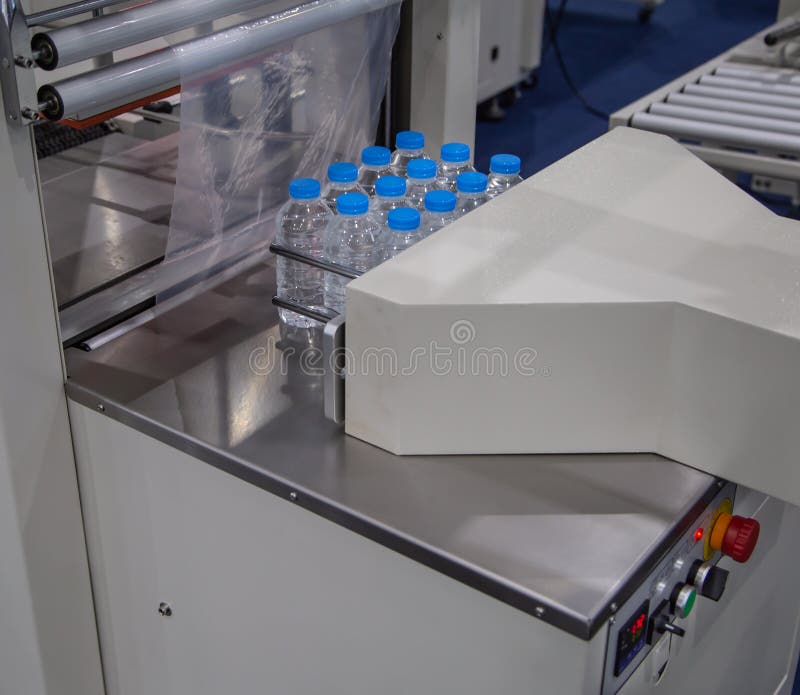 Automatic shrink film wrapping machine for bottle of water. Automatic shrink film wrapping machine for bottle of water