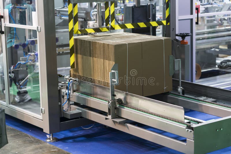 Automatic packing machine with plastic bag and paper box, high speed packing machine for food product industrial, high technology manufacturing process. Automatic packing machine with plastic bag and paper box, high speed packing machine for food product industrial, high technology manufacturing process