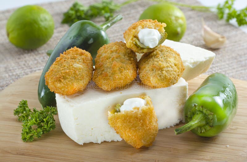 Mexican-american jalapeno poppers served with lime . Mexican-american jalapeno poppers served with lime .